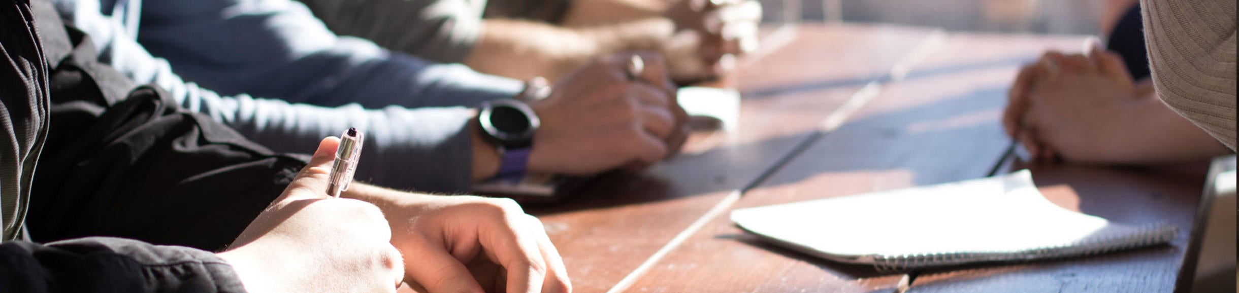 Hands on desk at meeting