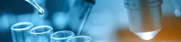microscope with lab glassware (c) istock