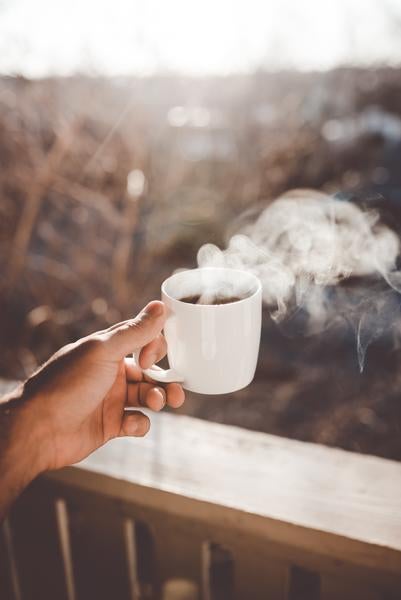 hand holding mug of coffee