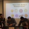 Three male scientists standing in front of a slide that states "Now lets build a Nanoparticle"